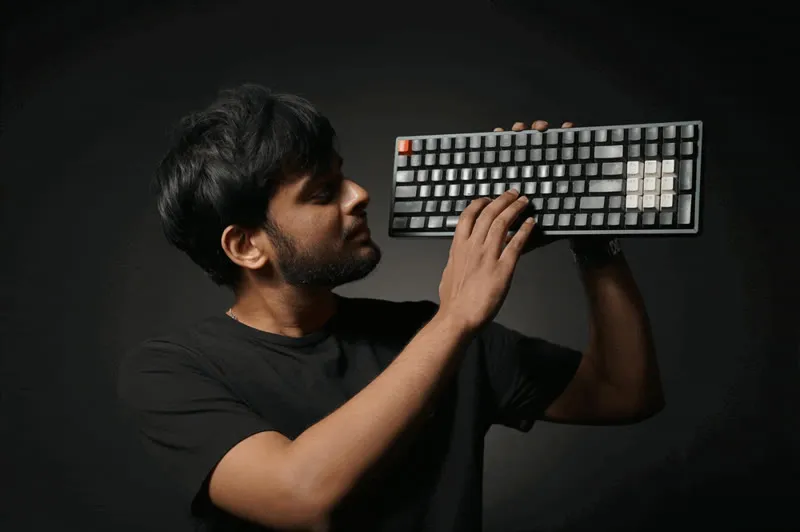 meet, mid-flip, holding a keyboard